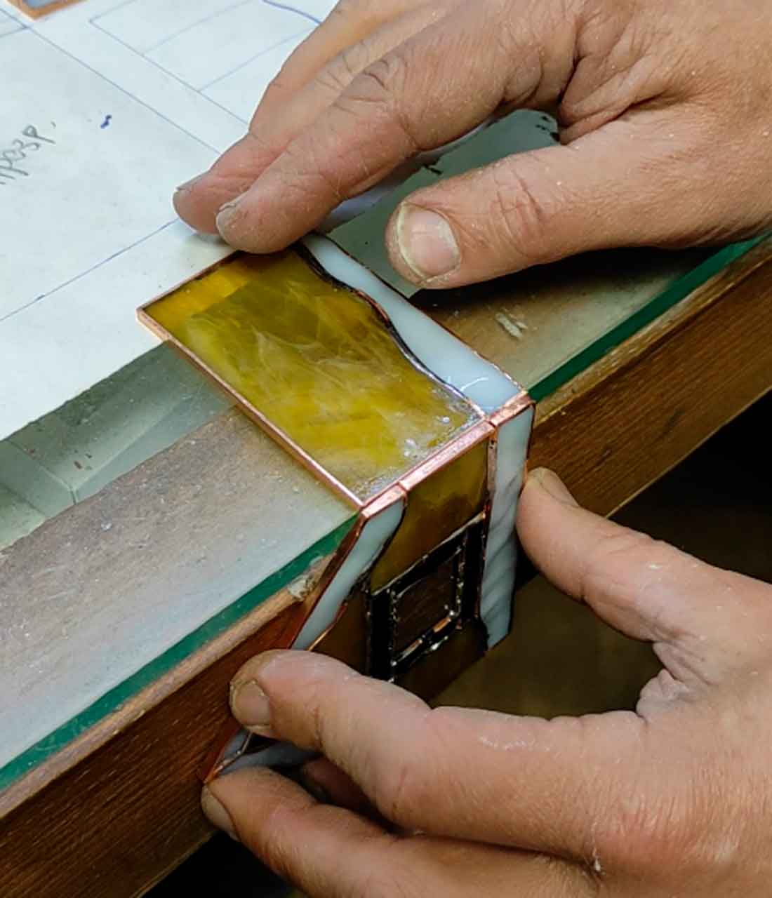 Using table corner as 90-degree guide for 3D Christmas house assembly