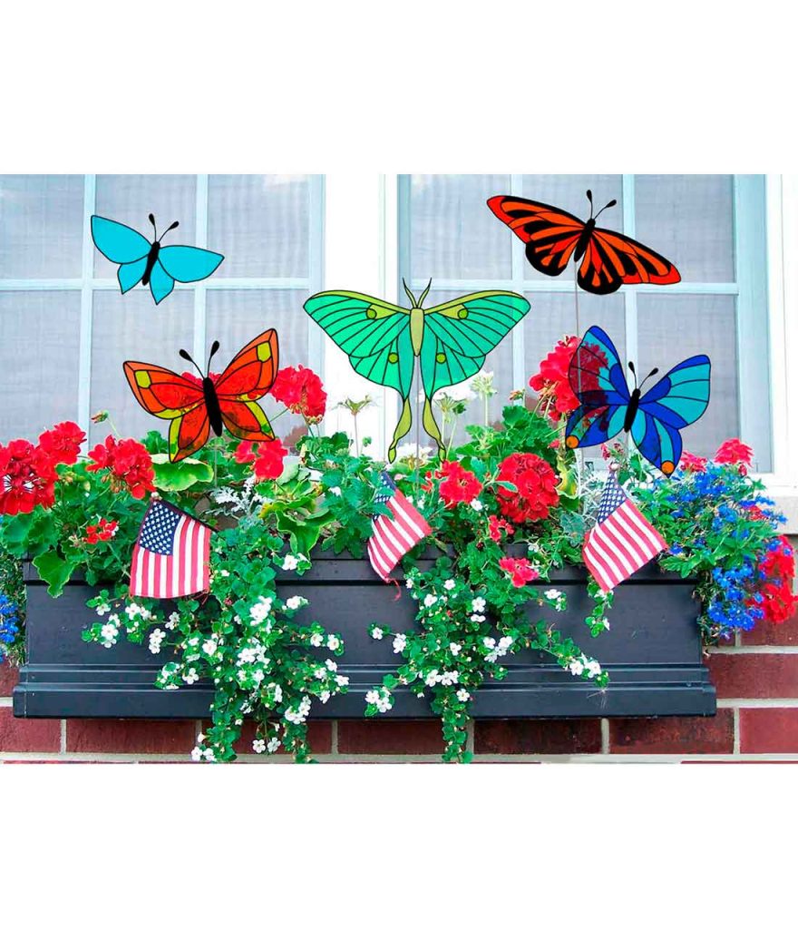 butterflies on stake in pots with house plants.