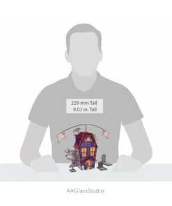 Get a true sense of scale for this detailed haunted house night light, held in hands to show it's a substantial and spooky home decor statement.