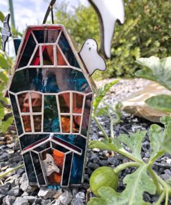 Spooky Halloween decor glowing beautifully on a windowsill, a creepy and cute addition to your home.