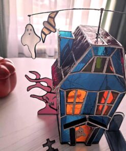 Halloween decor glowing beautifully on a windowsill, a creepy and cute addition to your home.