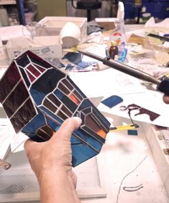 Gothic home decor, a miniature haunted mansion crafted from soldered glass panels for a vintage look.