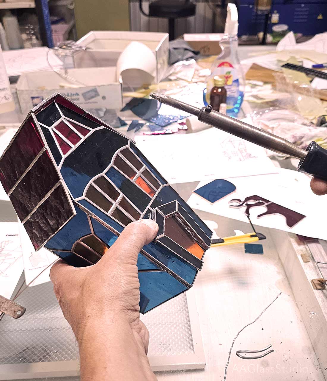 Gothic home decor, a miniature haunted mansion crafted from soldered glass panels for a vintage look.