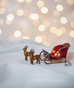 stained glass display of a beautiful stained glass sleigh photographed against a festive, softly lit background.
