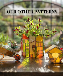 Handcrafted 3d stained glass pieces arranged on a windowsill: a garden wheelbarrow with succulents, a tiny birdhouse, and a house planter, showcasing vibrant glass art.