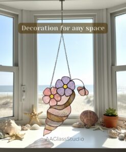 Floral seashell stained glass suncatcher hanging in a bright window for nautical home decor.