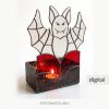 Spooky spider web stained glass candle holder with a green cabochon spider on a white background