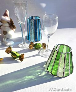 Stained glass lampshade on green and blue glasses. Interior decor