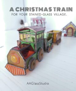3D stained glass Christmas train pattern: a green locomotive with amber wheels and two wagons, displayed in front of a stained glass Christmas village